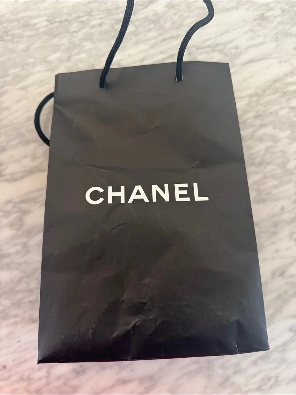 Chanel black logo matte paper gift bag + bonus eye makeup instruction booklet.